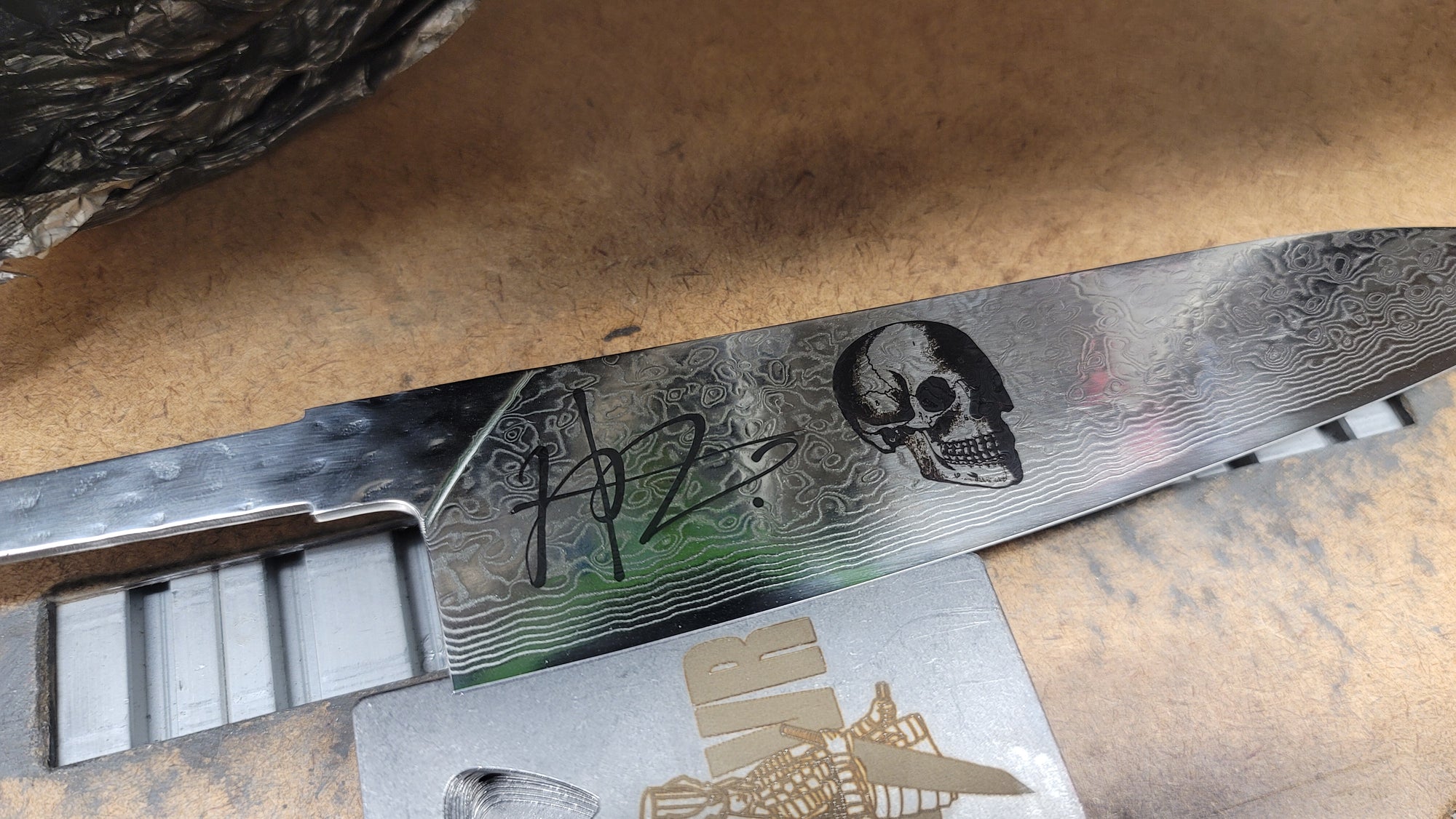 Signature and Skull Engraving on Soul Built KRVR damascus chef knife blade